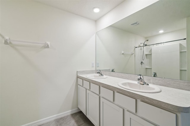 4119 Autumn Amber Dr, Spring Hill, FL 34609 - bathroom featuring double vanity, tile patterned floors, a shower, and recessed lighting