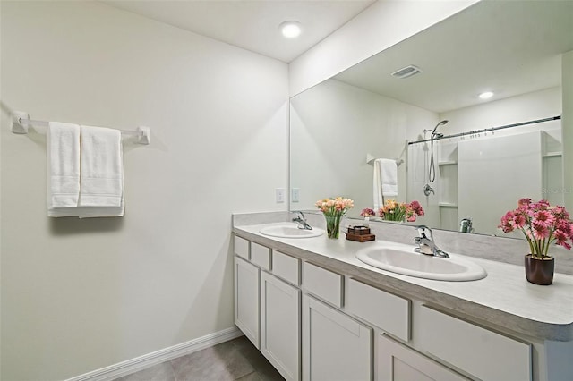 4119 Autumn Amber Dr, Spring Hill, FL 34609 - bathroom with double vanity, tile patterned flooring, and a shower