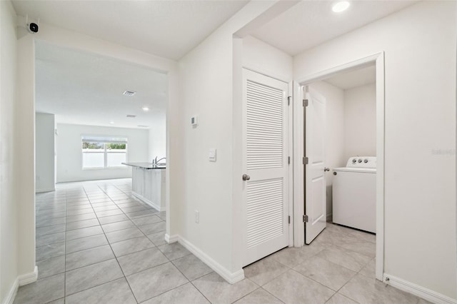 4119 Autumn Amber Dr, Spring Hill, FL 34609 - hall with washer / clothes dryer, light tile patterned floors, and recessed lighting