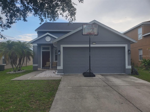 10109 36th Ct E, Parrish, FL 34219 - view of front of home with concrete driveway, an attached garage, a front lawn, and stucco siding