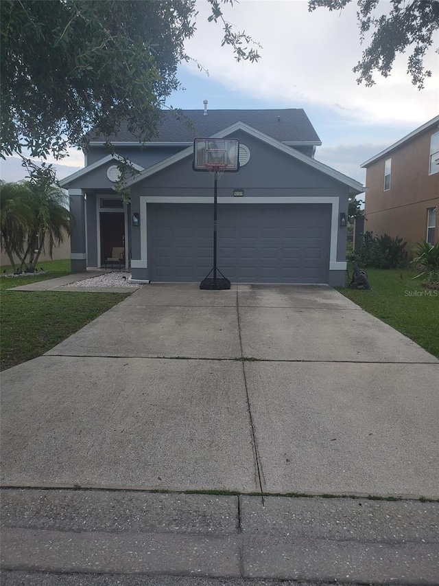 10109 36th Ct E, Parrish, FL 34219 - view of front of property featuring a garage, driveway, a front lawn, and stucco siding