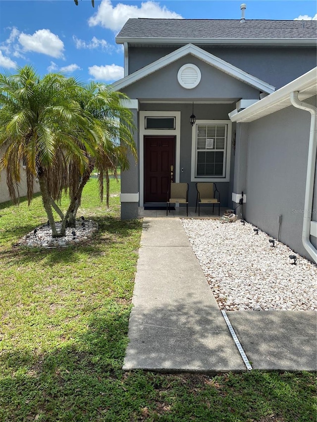 10109 36th Ct E, Parrish, FL 34219 - doorway to property with covered porch, stucco siding, and a yard