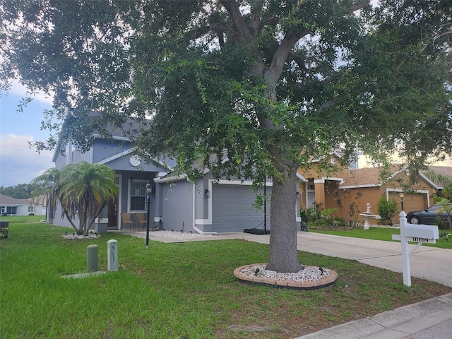 10109 36th Ct E, Parrish, FL 34219 - obstructed view of property featuring driveway, a front lawn, an attached garage, and stucco siding
