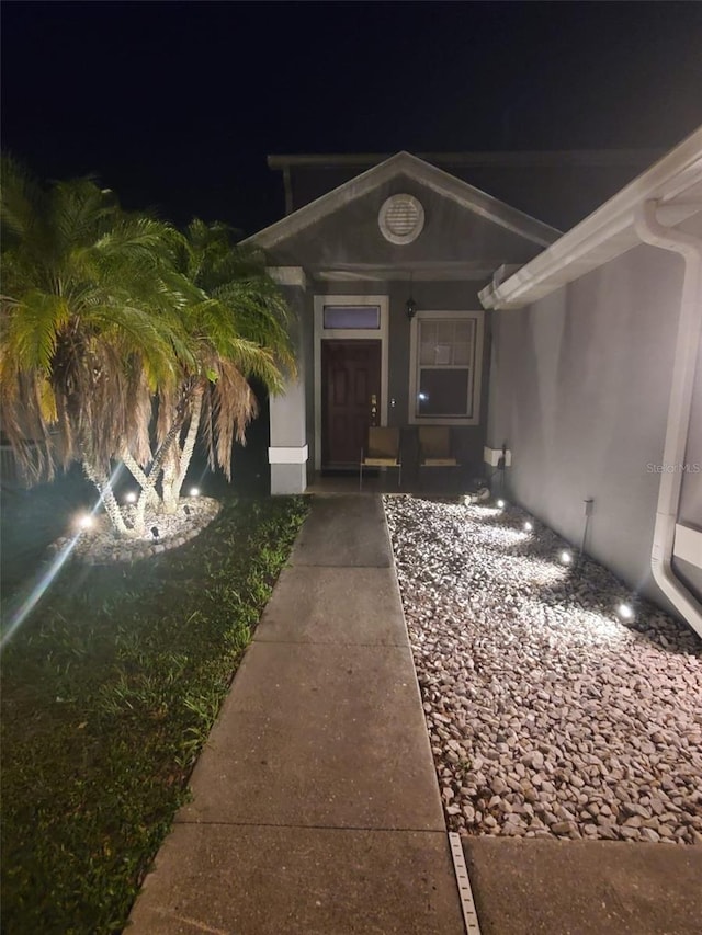 10109 36th Ct E, Parrish, FL 34219 - exterior entry at twilight featuring stucco siding