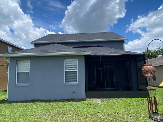 10109 36th Ct E, Parrish, FL 34219 - back of house featuring a sunroom, a lawn, and a shingled roof