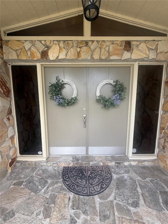 2215 Toniwood Ln, Palm Harbor, FL 34685 - doorway to property featuring stone siding