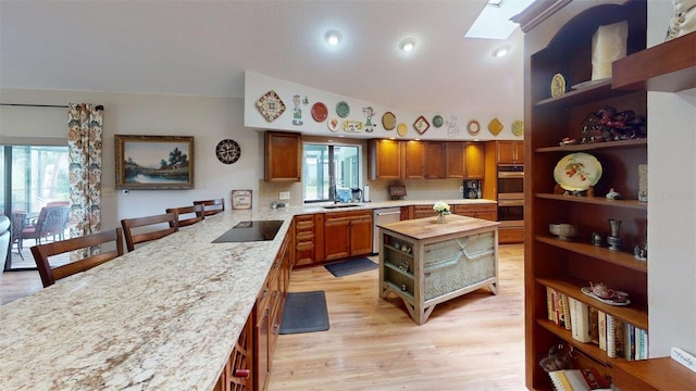 2215 Toniwood Ln, Palm Harbor, FL 34685 - kitchen with open shelves, wooden counters, stainless steel appliances, a skylight, and a peninsula