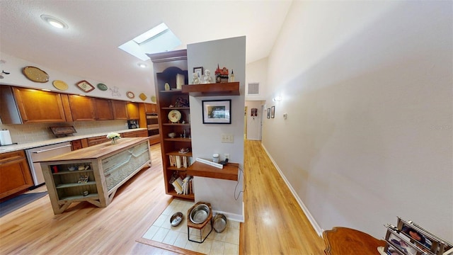2215 Toniwood Ln, Palm Harbor, FL 34685 - dining room featuring a skylight and light wood-style floors