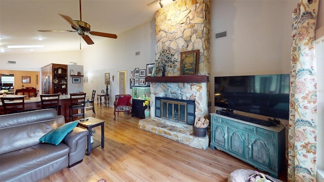 2215 Toniwood Ln, Palm Harbor, FL 34685 - living area with a ceiling fan, light wood finished floors, a fireplace, and high vaulted ceiling