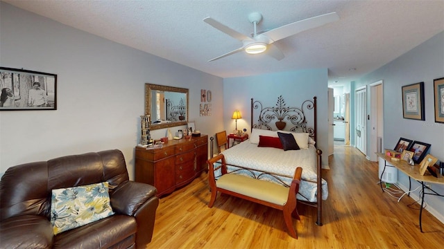2215 Toniwood Ln, Palm Harbor, FL 34685 - bedroom featuring light wood finished floors, ceiling fan, and a textured ceiling