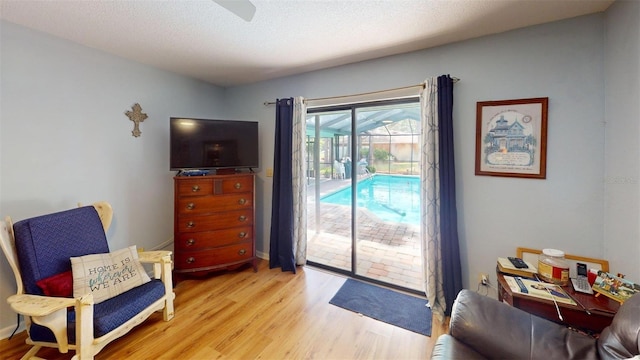 2215 Toniwood Ln, Palm Harbor, FL 34685 - sitting room with light wood-style flooring and ceiling fan