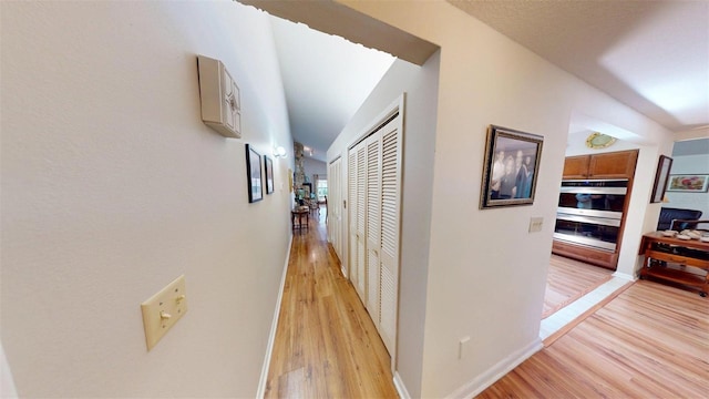 2215 Toniwood Ln, Palm Harbor, FL 34685 - hall with light wood finished floors and baseboards