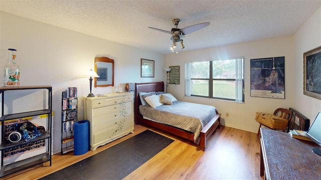 2215 Toniwood Ln, Palm Harbor, FL 34685 - bedroom featuring wood finished floors, a textured ceiling, and a ceiling fan