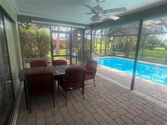 2215 Toniwood Ln, Palm Harbor, FL 34685 - outdoor pool featuring a patio area, ceiling fan, and glass enclosure