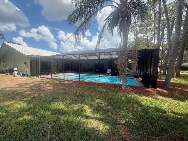 2215 Toniwood Ln, Palm Harbor, FL 34685 - outdoor pool featuring glass enclosure and a lawn
