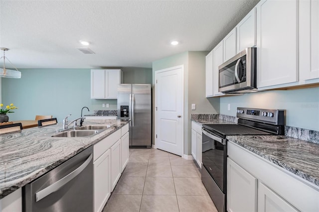 13304 Mylion Way, Spring Hill, FL 34610 - kitchen with appliances with stainless steel finishes, white cabinets, recessed lighting, and a textured ceiling