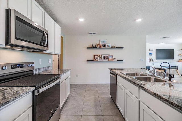 13304 Mylion Way, Spring Hill, FL 34610 - kitchen with appliances with stainless steel finishes, open shelves, white cabinetry, a textured ceiling, and recessed lighting