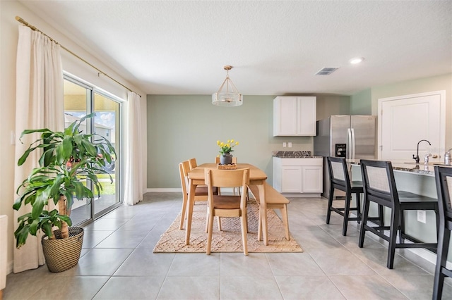 13304 Mylion Way, Spring Hill, FL 34610 - dining space featuring a textured ceiling and light tile patterned flooring