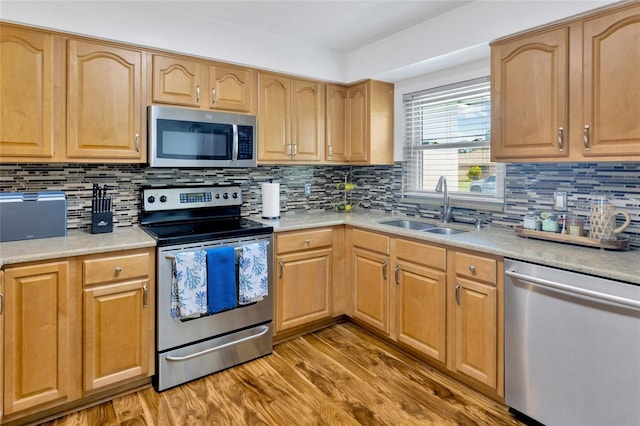 10811 Providence Oaks Dr, Riverview, FL 33578 - kitchen featuring appliances with stainless steel finishes, light wood-style flooring, tasteful backsplash, and light countertops