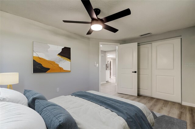 7031 Magnolia Valley Dr, New Port Richey, FL 34653 - bedroom featuring wood finished floors, a ceiling fan, and a closet