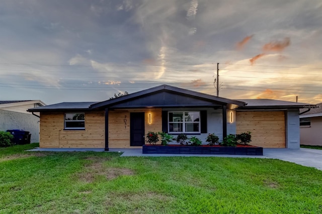 7031 Magnolia Valley Dr, New Port Richey, FL 34653 - ranch-style home featuring a front lawn, an attached garage, and concrete driveway