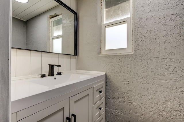 7031 Magnolia Valley Dr, New Port Richey, FL 34653 - bathroom with vanity and a textured wall