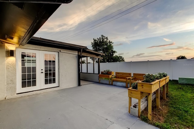 7031 Magnolia Valley Dr, New Port Richey, FL 34653 - patio terrace at dusk with french doors and a patio area