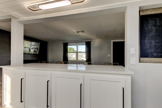 7031 Magnolia Valley Dr, New Port Richey, FL 34653 - kitchen featuring white cabinetry, light countertops, and open floor plan