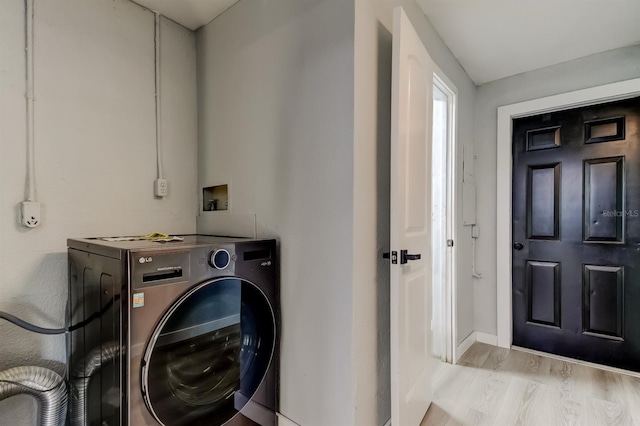 7031 Magnolia Valley Dr, New Port Richey, FL 34653 - laundry room with washer / dryer and wood finished floors
