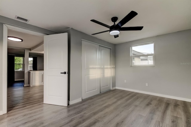 7031 Magnolia Valley Dr, New Port Richey, FL 34653 - unfurnished bedroom with wood finished floors and ceiling fan