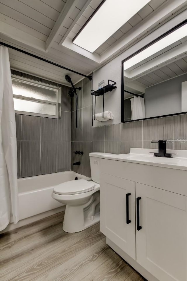 7031 Magnolia Valley Dr, New Port Richey, FL 34653 - full bathroom with tile walls, vanity, shower / bath combo, and wood finished floors