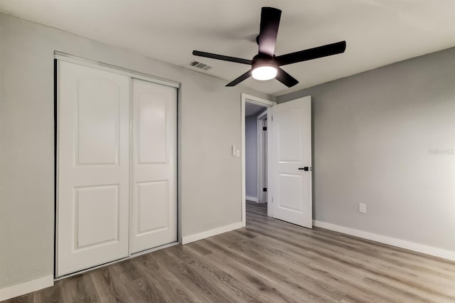7031 Magnolia Valley Dr, New Port Richey, FL 34653 - unfurnished bedroom with a closet, wood finished floors, and a ceiling fan