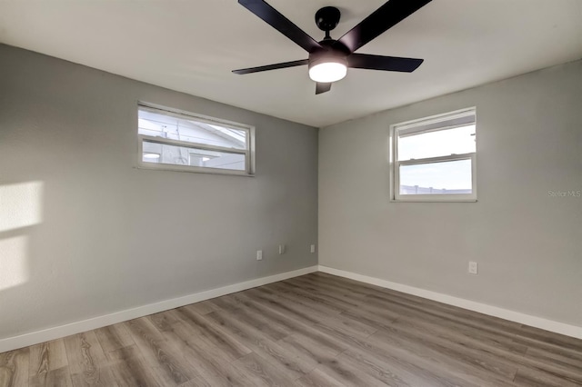 7031 Magnolia Valley Dr, New Port Richey, FL 34653 - spare room featuring plenty of natural light, wood finished floors, and ceiling fan