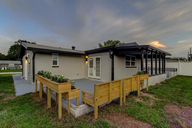 7031 Magnolia Valley Dr, New Port Richey, FL 34653 - rear view of property featuring french doors and stucco siding