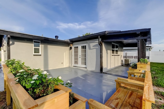 7031 Magnolia Valley Dr, New Port Richey, FL 34653 - rear view of house featuring french doors, a patio area, and stucco siding