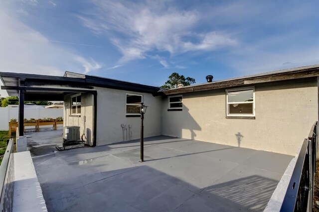7031 Magnolia Valley Dr, New Port Richey, FL 34653 - back of house with stucco siding and a patio area