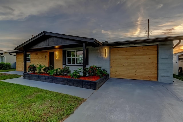 7031 Magnolia Valley Dr, New Port Richey, FL 34653 - view of front of home with driveway, a garage, and brick siding