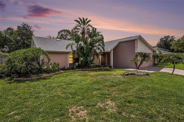 3335 Foxridge Cir, Tampa, FL 33618 - mid-century modern home featuring concrete driveway, a garage, a front yard, and stucco siding