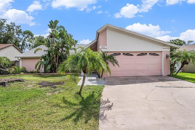 3335 Foxridge Cir, Tampa, FL 33618 - mid-century modern home with driveway, a front lawn, and an attached garage