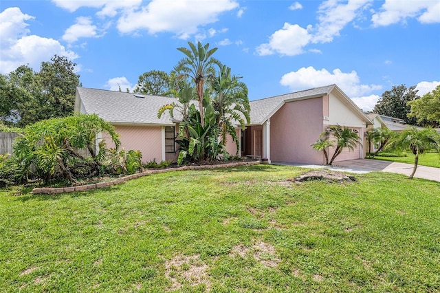 3335 Foxridge Cir, Tampa, FL 33618 - mid-century home featuring driveway, a garage, a front lawn, and stucco siding