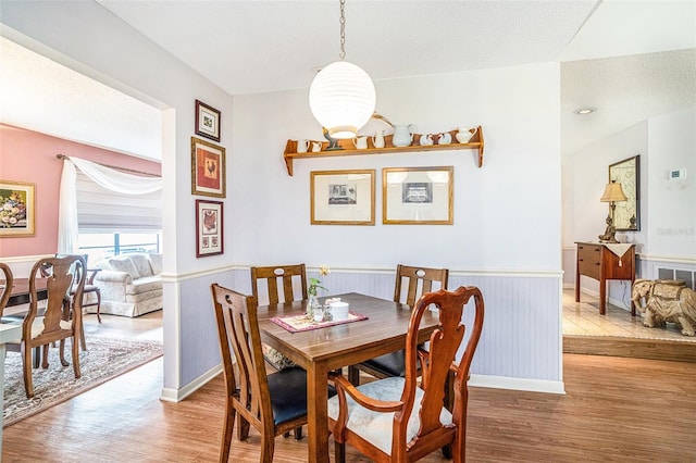 3335 Foxridge Cir, Tampa, FL 33618 - dining space with light wood-type flooring and a wainscoted wall