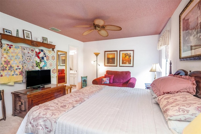 3335 Foxridge Cir, Tampa, FL 33618 - bedroom with a textured ceiling, carpet flooring, a ceiling fan, and connected bathroom