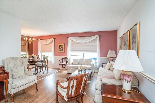 3335 Foxridge Cir, Tampa, FL 33618 - living room featuring a chandelier, wood finished floors, and a textured ceiling