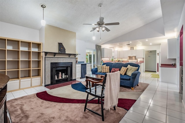 1810 Orange Hill Dr, Brandon, FL 33510 - living room featuring light tile patterned flooring, a textured ceiling, vaulted ceiling, ceiling fan, and a tiled fireplace