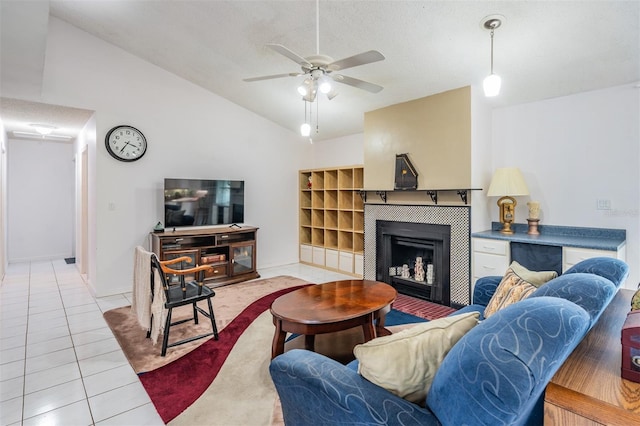 1810 Orange Hill Dr, Brandon, FL 33510 - living room featuring tile patterned floors, ceiling fan, vaulted ceiling, and a tile fireplace