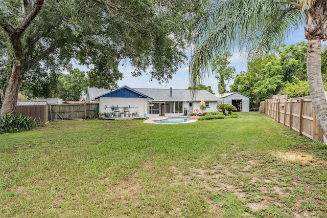 1810 Orange Hill Dr, Brandon, FL 33510 - rear view of house with a fenced backyard, a gate, and a storage unit