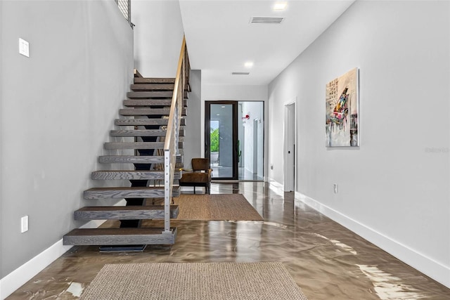 131 Forest Hills Dr, Redington Shores, FL 33708 - foyer with stairs and baseboards