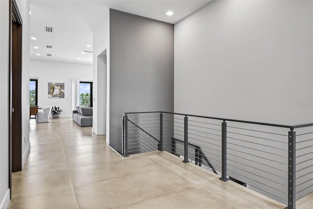 131 Forest Hills Dr, Redington Shores, FL 33708 - hallway with an upstairs landing, recessed lighting, a towering ceiling, and concrete flooring