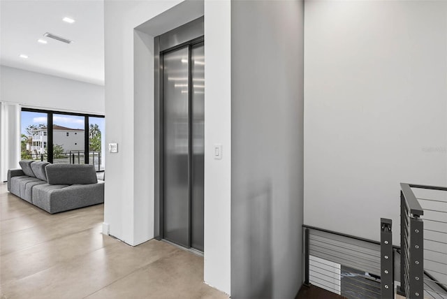 131 Forest Hills Dr, Redington Shores, FL 33708 - corridor featuring elevator, concrete flooring, and recessed lighting