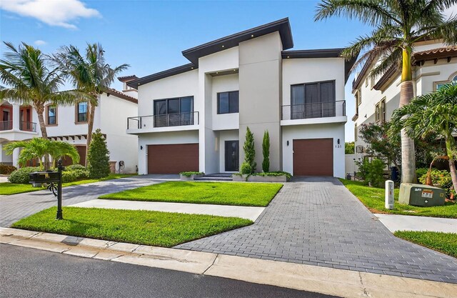 131 Forest Hills Dr, Redington Shores, FL 33708 - contemporary home featuring stucco siding, asphalt driveway, a balcony, and a garage